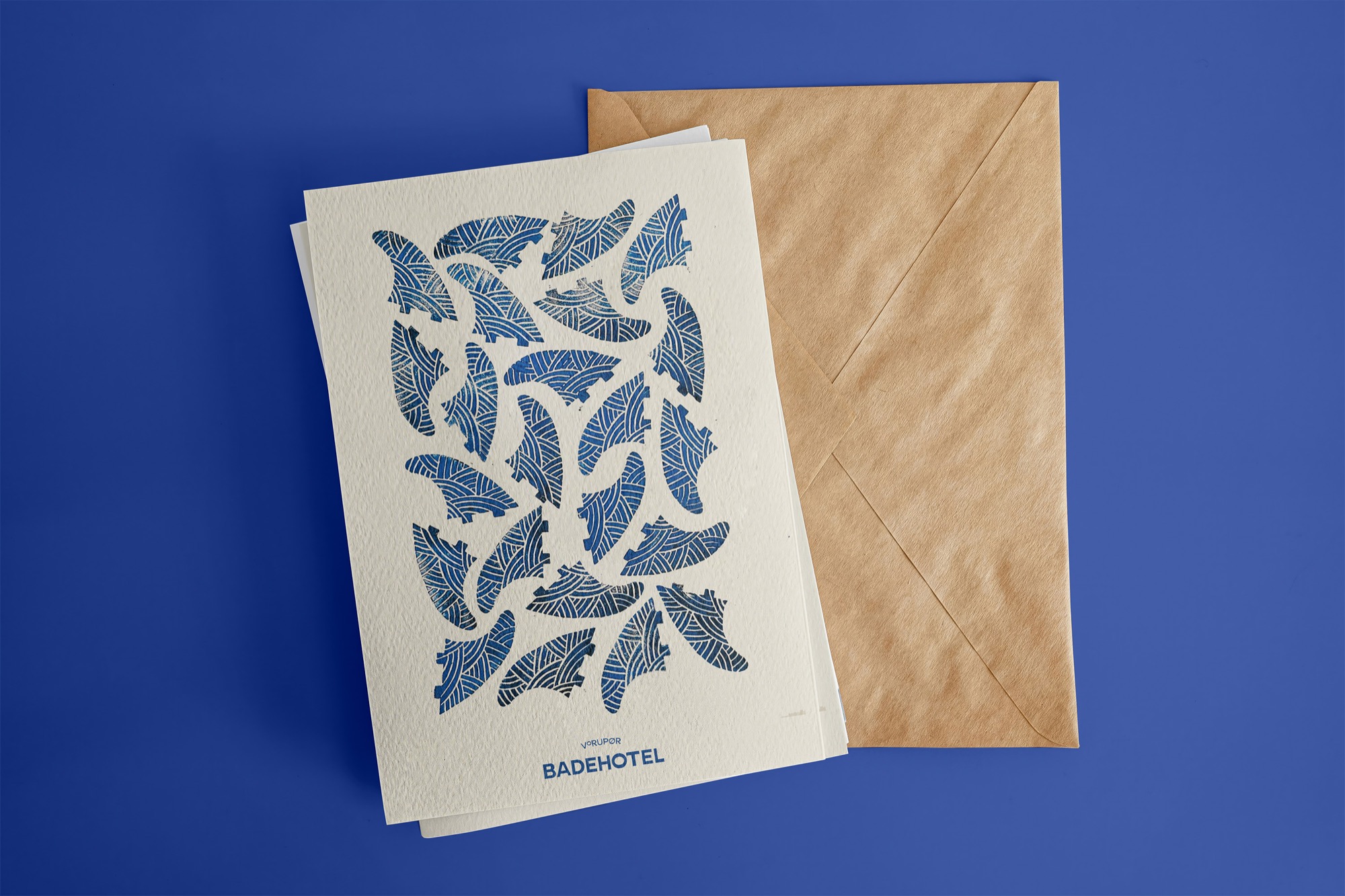 Vorupør Badehotel cards printed with a pattern of blue surfboard fins, with a kraft envelope